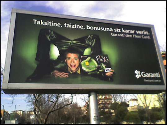 Daniel contorting in a chest stand on a billboard in Turkey